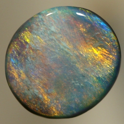 SOLID BLACK OPAL Golden fire of red and copper over a green - blue background
